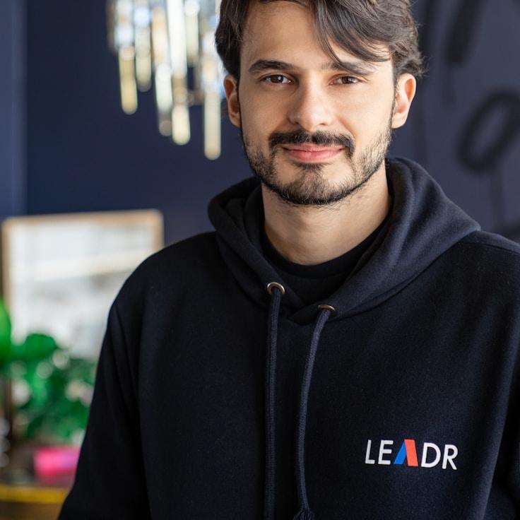 Avery Chen, Lead Design Curator at RootMallowCurrent, reviewing corporate floral arrangements